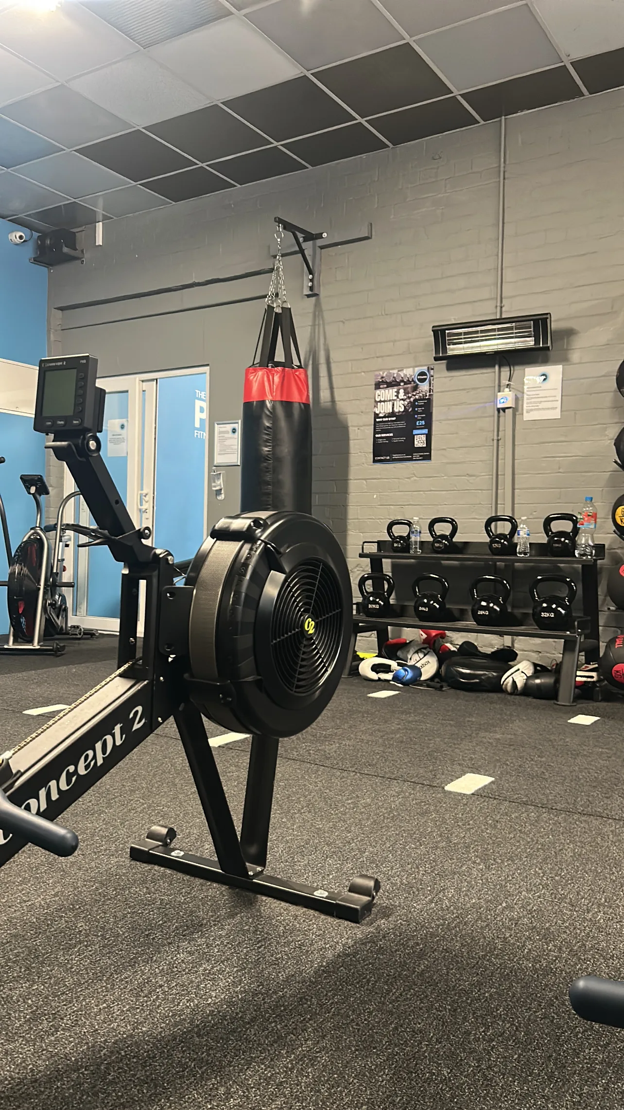The PT Factory gym in Denton, Manchester - rowing machine, boxing bag and weights